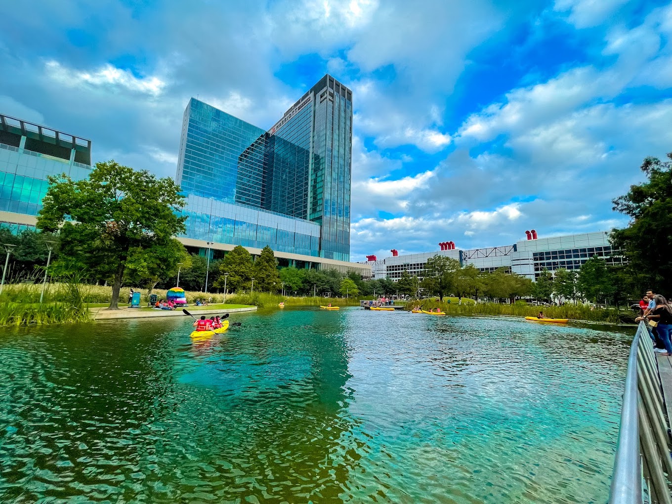 Kayakers on Kinder Lake at Discovery Green with the Marriott Marquis tower behind