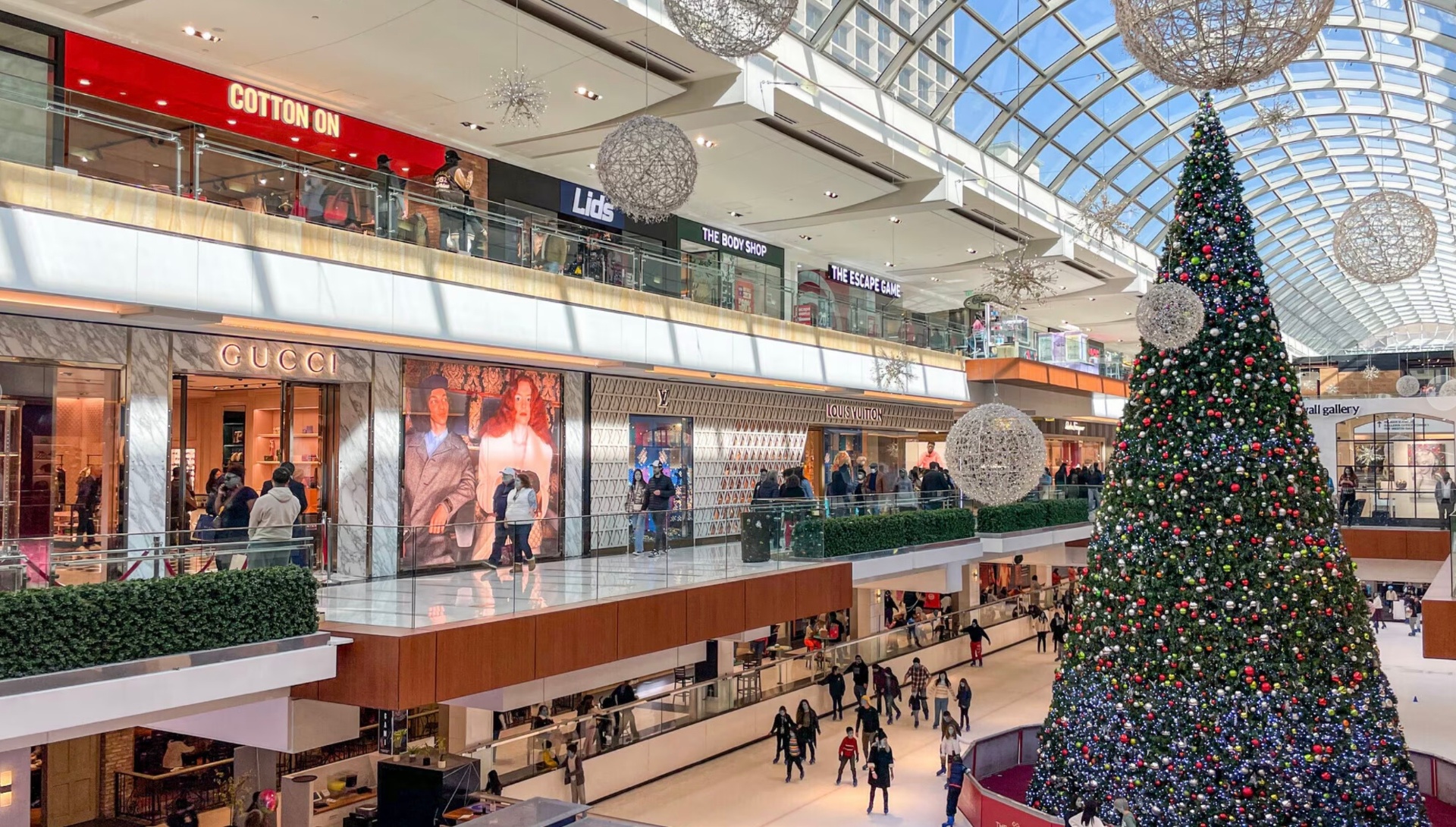 The Houston Galleria interior with the ice rink, glass atrium, and luxury storefronts including Gucci and Louis Vuitton
