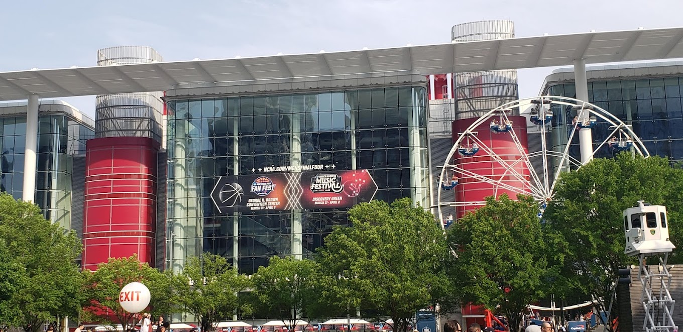 George R. Brown Convention Center facade with red columns and the Ferris wheel at Avenida Houston
